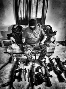 Sinaloa man prepares to clean guns. (Nick Quested)