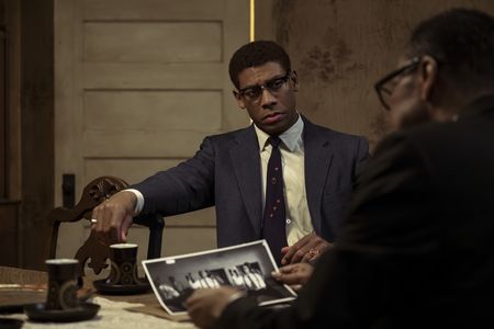 Malcom X, played by Aaron Pierre, shows photos to Elijah Muhammad, played by Ron Cephas Jones, in GENIUS: MLK/X. (National Geographic/Richard DuCree)