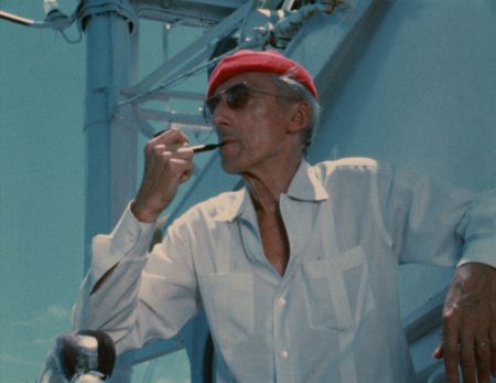 BECOMING COUSTEAU - Jacques Cousteau wears his iconic red diving cap aboard his ship Calypso, circa 1970s. (Credit: The Cousteau Society)