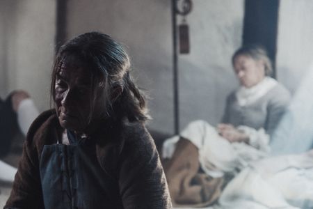 A group of prisoners sat inside Toll Booth Prison. A prisoner looks down at the floor dispirited  (Dash Productions Services LTD/Antoan Ivanov)