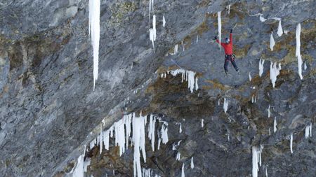 Will Gadd hangs from his ice tools as he ascends Helmcken Falls.  (mandatory credit: Red Bull Media House)