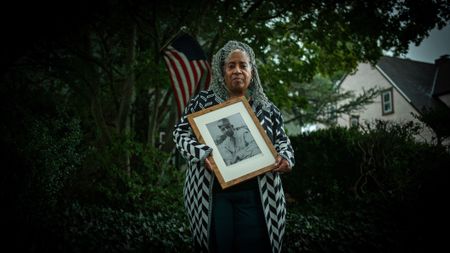 Carole Johnson holds a photograph of her father, E.G. McConnell, during an interview at her home in N.Y. Private First Class E.G. McConnell served heroically with the 761st Black Panther Tank Battalion in WW2. (National Geographic/Fabian Mandujano)