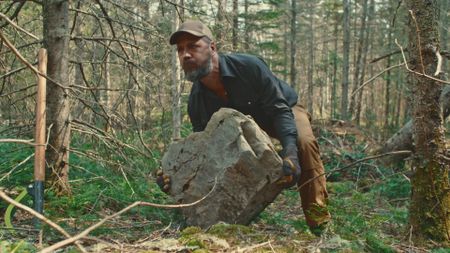 Billy lifts a heavy rock. (Blue Ant Media/Tara Elwood)