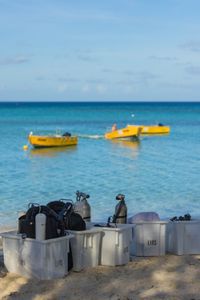 Dive equipment organized on the beach in preparation to be loaded on boats so crew can go out and film Day octopus on the Great Barrier Reef.   (photo credit: National Geographic/Harriet Spark)
