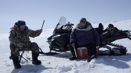 John and Teresa Pingayak ice fishing in the winter. (National Geographic/Matt Kynoch)