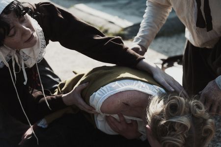 Villagers hold Mary Dunbar as a scar appears on her shoulder. (Dash Productions Services LTD/Antoan Ivanov)