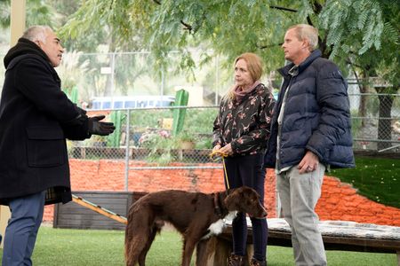 Cesar talks with Melissa and Mike while Murphy is held on leash. (National Geographic)