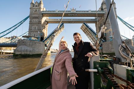 Florence Pugh and Antoni Porowksi pose as they cross under Tower Bridge. (National Geographic/Chris Raphael)