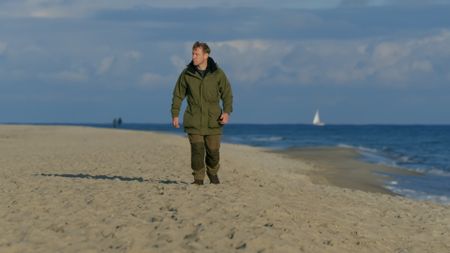 Andy Torbet walking on sand. (National Geographic)