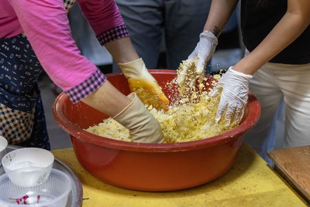 Yoon Hee Lee and Awkwafina make tteok, a sweet cake made from rice flour. (Credit: National Geographic/Seong Joon Cho)