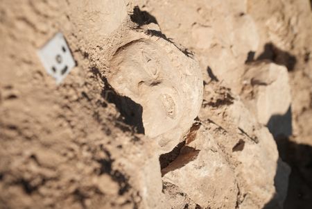 In this behind-the-scenes photo, crew member Andrew Richens takes a close-up photo of the fresh find at the dig site in Amman, Jordan. (Windfall Films/Alex Collinge)