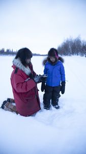 Ricko DeWilde teaches his son, Keenan DeWilde how to set up fur traps during the trapping season. (BBC Studios Reality Productions, LLC/JR Masters)