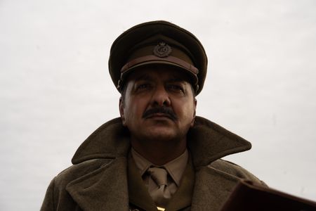 Major Akbar Khan (played by Jack Gill) is pictured in close-up portrait in a WW2 historic reenactment scene for "Erased: WW2's Heroes of Color." Major Akbar Khan was the most senior Indian in the British Army during WW2 and a member of Force K6, a little known Indian regiment of mule handlers. Amidst the chaos of Dunkirk and the advancing German Army, the Indian regiment fought for victory and independence. (National Geographic/Harriet Laws Herd)