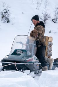 Johnny Rolfe and his dog Java riding on his snowmobile. (BBC Studios Reality Production/Patrick Henderson)