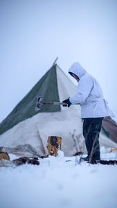 Chip Hailstone chops wood for their family camp. (BBC Studios Reality Productions/Ashton Hurlburt)