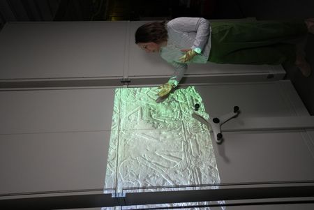 Dr Iwona J. Kozieradzka-Ogunmakin looks at an ancient Egyptian stele of the Israelites at the Manchester Museum in Manchester, UK. (Windfall Films)