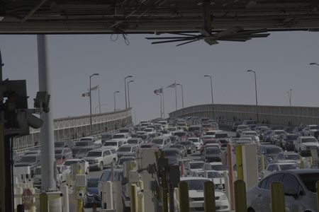 Multiple vehicles wait in line to cross at the El Paso border in El Paso, Texas. (National Geographic)