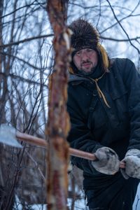 Chevie Roach gathers branches to build a blind during the migratory water fowl hunting season. (BBC Studios Reality Productions/Jayce Kolinski)