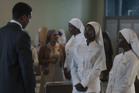 Malcolm X, played by Aaron Pierre, greets Betty, played by Jayme Lawson, and Sister Grace, played by Elle Lorraine, in GENIUS: MLK/X. (National Geographic/Richard DuCree)