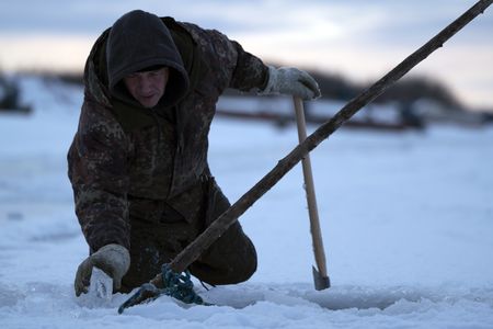 Chip Hailstone installs fish nets under the ice to catch whitefish. (BBC Studios Reality Productions, LLC/Dwayne Fowler)