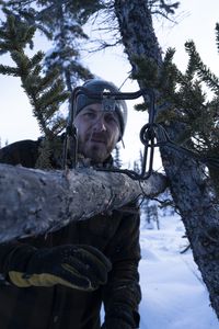 Johnny Rolfe sets a conibear  trap before the prime fur trapping season is over. (BBC Studios Reality Productions, LLC/Tyler Colgan)