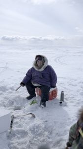 Teresa Pingayak ice fishing. (National Geographic/Matt Kynoch)