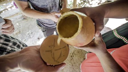 A local drink is shared with friends out of a gourd in Hacienda Mamecillo, Boquete, Panama. (National Geographic for Disney/Missy Bania)