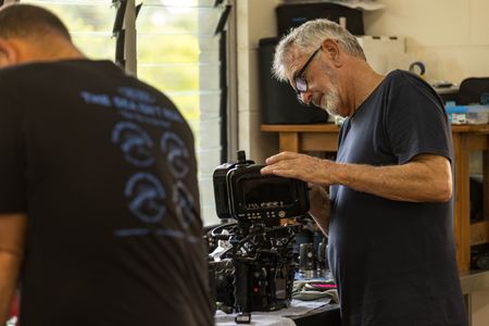 Camera assistant, Woody Spark, and cinematographer, Rory McGuinness, preparing cameras to film the Day octopus sequence on the Great Barrier Reef.   (photo credit: National Geographic/Harriet Spark)