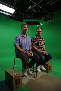 Randy and Jason Sklar sitting and laughing Infront of green screen. (National Geographic/Robert Toth)