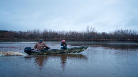 Chevie Roach and his daughter, Sydney travel across the Innoko River in search of beaver. (BBC Studios/Brian Bitterfeld)