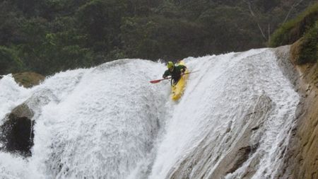 Evan Garcia kayaks down a waterfall on the Santo Domingo river, in Mexico.  (mandatory photo credit: Rush Sturges / River Roots Productions)