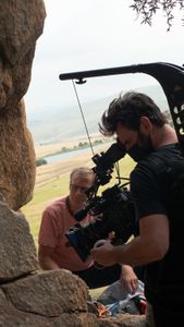 Conrad Anker unpacks his climbing bag while cinematographer Nick Kraus films him.  (National Geographic/Elena Gaby)