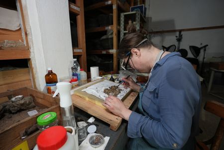 Alexandra Winkels carefully restores and cleans old fresco artefacts at Pi Ramesses, Egypt. (Windfall Films)