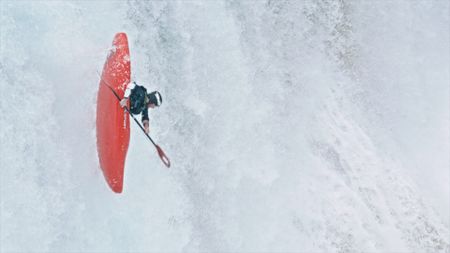 Kayaking down a waterfall.  (mandatory photo credit: Rush Sturges / River Roots Productions)