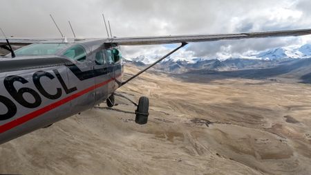 A plane flying over The Valley of Ten Thousand Smokes. (credit: National Geographic/Jeff Reed)