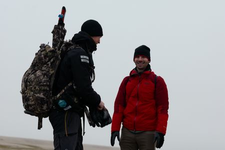 PolarX guide Tom Lawton and Eric Stackpole talking on Svalbard. (National Geographic/Mario Tadinac)