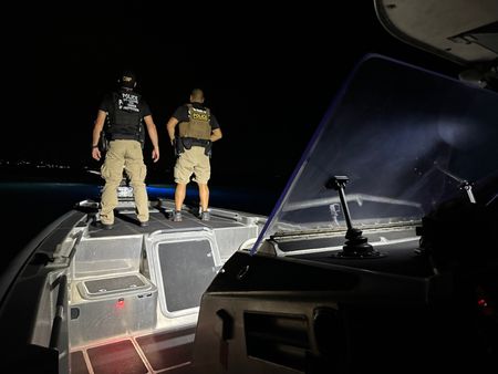 Two CBP Agents stands at the edge of an Interceptor Class Coastal Interceptor Vessel in St Thomas, USVI. (Lucky 8 TV)