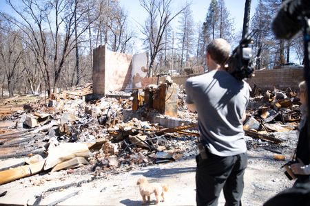 Paradise, CA - Director of Photography, Lincoln Else, films debris strewn property in Paradise, CA. (Credit: National Geographic/Lizz Morhaim)