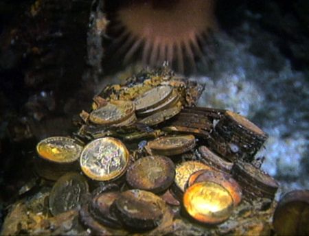 Gold coins are pictured on the bottom of the seabed off the coast of North Carolina, USA. In 1989, maverick scientist Tommy Thompson stuns the world by recovering three tons of gold from a shipwreck deep in the Atlantic Ocean. What follows is a 30-year story of adventure, deception, and personal turmoil, taking him from venerated celebrity to infamous fugitive, and finally a defiant prisoner who refuses to give up his gold. (Recovery Limited Partnership Liquidating Trust)