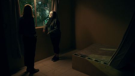 Mariana interviews Paloma in a dingy room. (National Geographic)