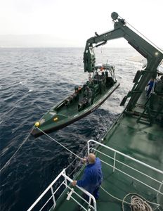 Civil Guard ship transfers and unloads one of its vessels on the high seas. (Guardia Civil)