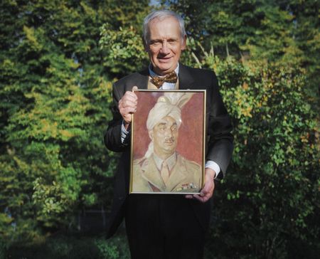 Expert consultant Dr. Ghee Bowman holds a portrait of Akbar Khan outside his home in Exeter, England. Major Akbar Khan was the most senior Indian in the British Army during WW2 and a member of Force K6, a little known Indian regiment of mule handlers. Amidst the chaos of Dunkirk and the advancing German Army, the Indian regiment fought for victory and independence. (National Geographic/Daniel Dewsbury)