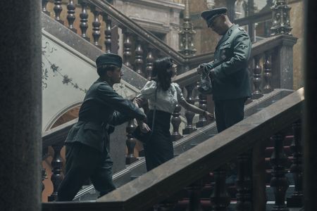 A SMALL LIGHT - Miep Gies, played by Bel Powley, is removed from the Gestapo Headquarters as seen in A SMALL LIGHT. (Credit: National Geographic for Disney/Dusan Martincek)