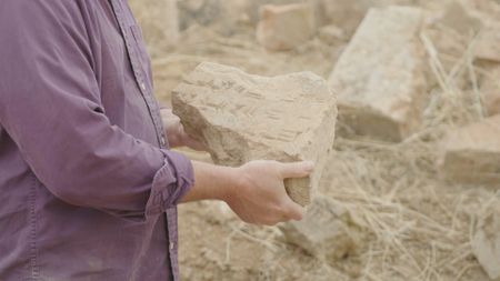 Michael Danti examines a new discovery at the active dig site in Nimrud, Iraq. (Windfall Films)