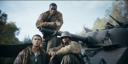 Staff Sergeant Johnnie Stevens, Loader Floyd Dade and Private First Class E.G McConnell (played by Juwon Adedokun, Dalumuzi Moyo and Ruffus Shutter, resp.) sit in front of a tank in a group photo during a historic reenactment of the Battle of the Bulge produced for "Erased: WW2's Heroes of Color." Stevens, Dade and McConnell served with the 761st Black Panther Tank Battalion in WW2. (National Geographic)