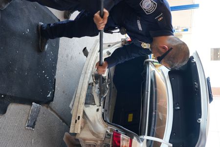 CBP officer Gutierrez dismantles the rear bumper of a suspect's vehicle to search for hidden contraband in El Paso, Texas. (National Geographic)