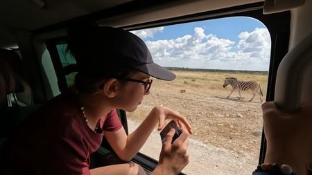 Mia Pelletier looks out the window while on safari in Namibia. (Credit: Edith Lemay)