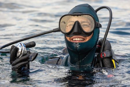 Storyteller and cephalopod expert, Dr Alex Schnell on the surface in full SCUBA gear.   (photo credit: National Geographic/Harriet Spark)