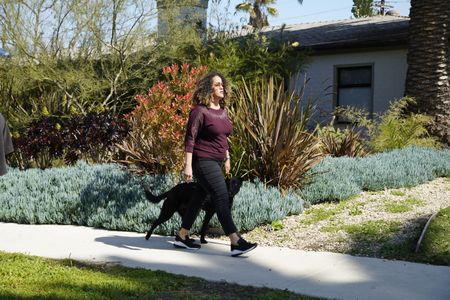 Bo completes a walking exercise with her dog Shadow. (National Geographic)