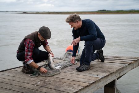 Iceland - L to R: Hakon teaches Gordon Ramsay how to fish for salmon the traditional way, using only a net. (Credit: National Geographic/Justin Mandel)